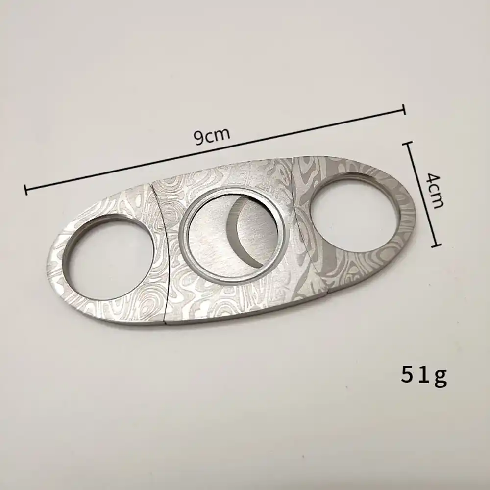 Damascus Cigar Cutter – Double Blade Stainless Steel | ProTravelHumidors 2 ProTravelHumidors Damascus pattern double blade cigar cutter – dimensions 9cm length x 4cm width, weight 51g – compact and travel‑friendly